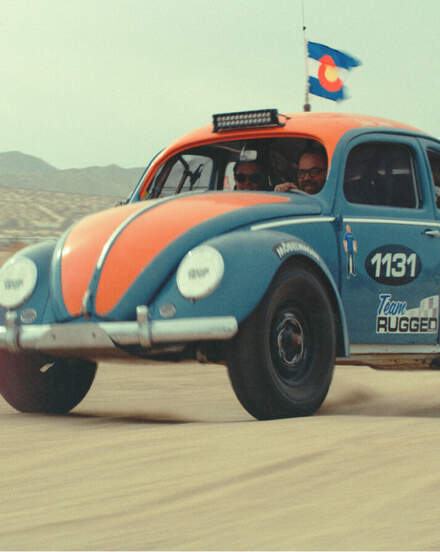Vintage Volkswagon Bug racing through the desert