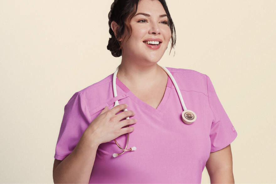 Women wearing pink scrubs with a stethpscope