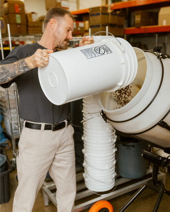 Man emptying grain into a container