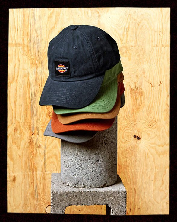 Hats sitting on a concrete cilinder