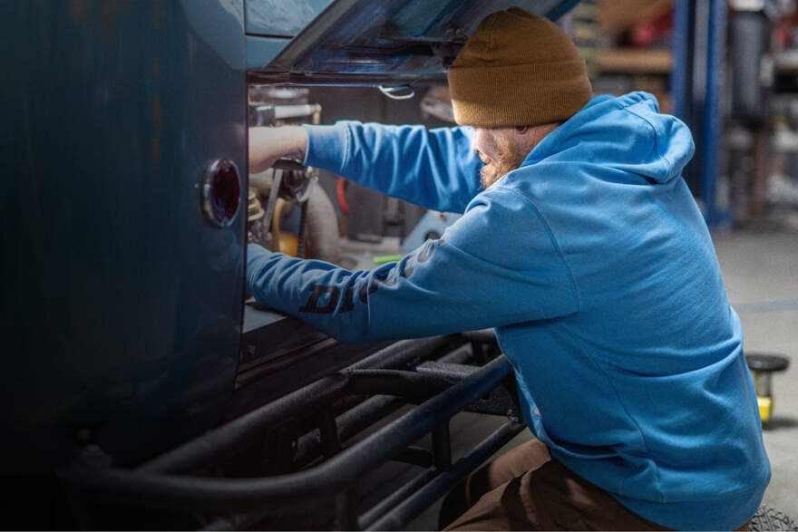 Man wearing blue Dickies hoodie while working