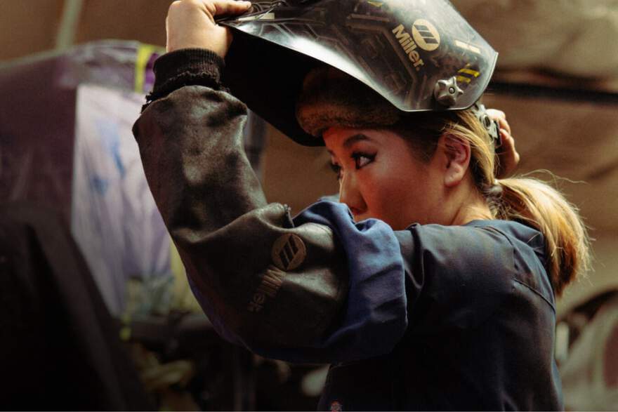 Woman in welding helmet work wear