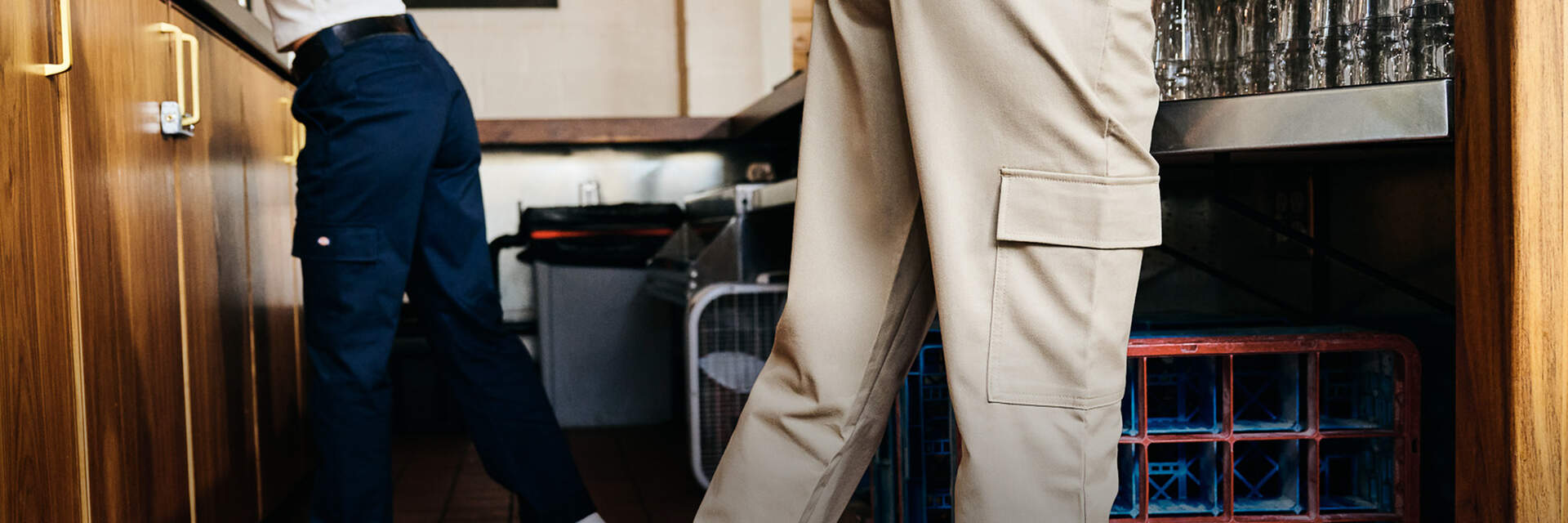 Women behind a bar working in Dickies super flex cargo pants in khaki and navy