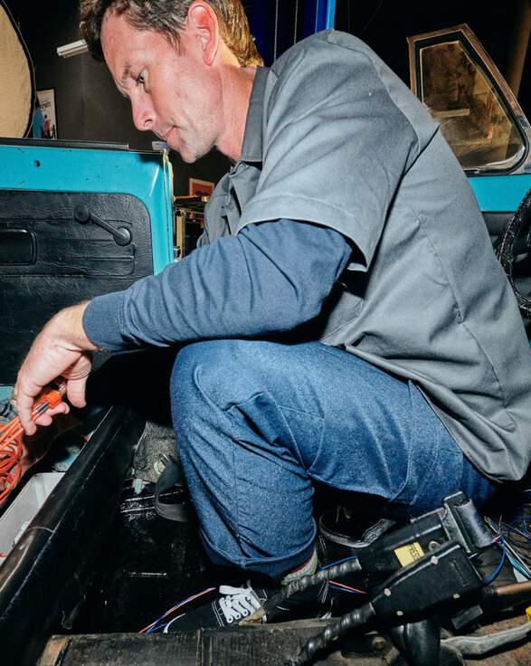 Man crouching down working on car