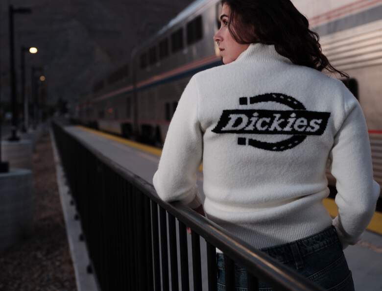 Woman wearing Dickies logo sweater in white with black image