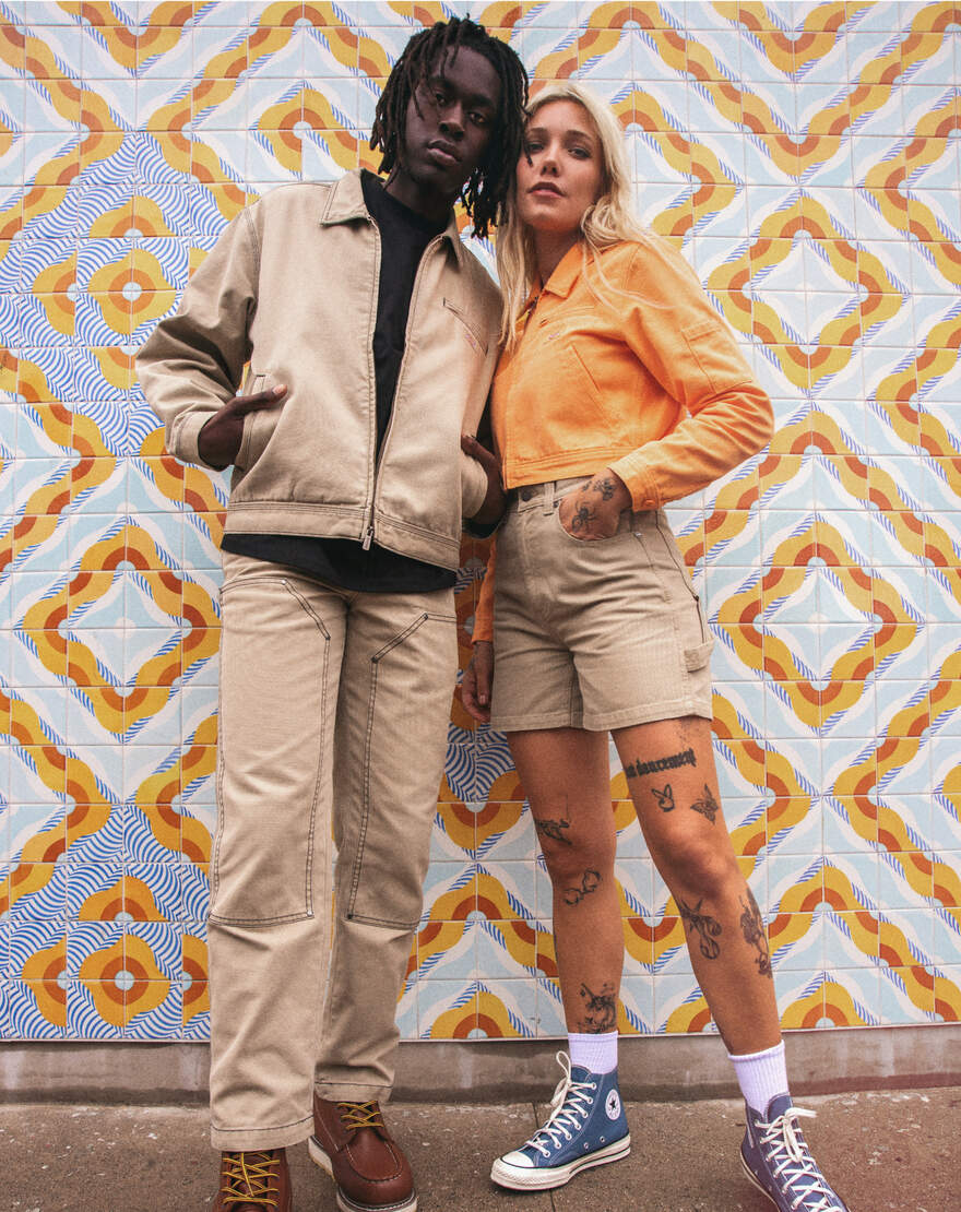 A stylish couple in Khaki in front of geometric tile