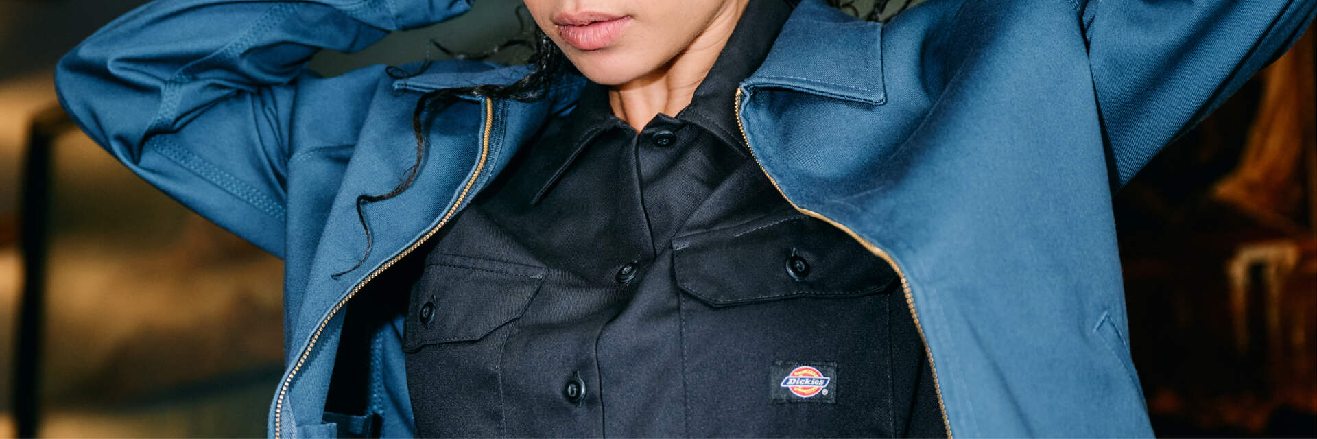 Man adjusting Dickies blue Eisenhower jacket