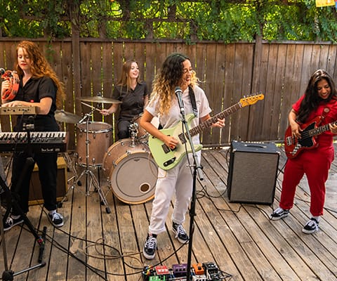 From left to right: Chelsea, Bailey, Ariel and Stephanie play a set in Dickies Flex Coveralls for women.