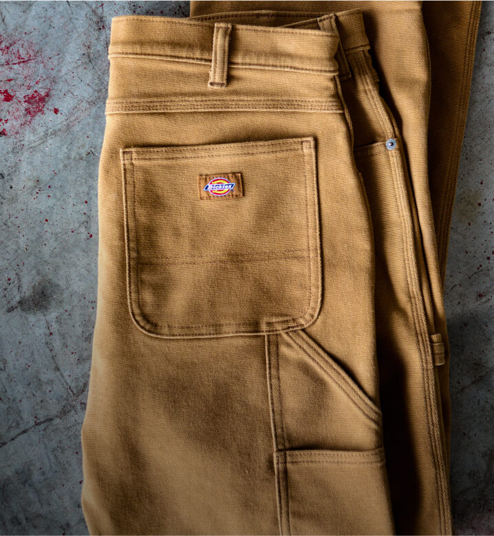 A tan pant laying on a textured surface.