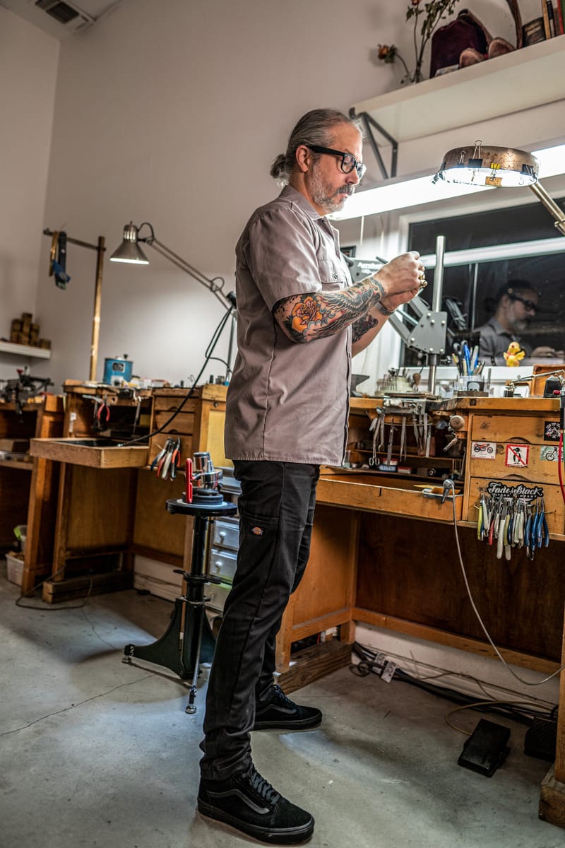 Branden’s workspace keeps his tools organized just like his multi-pocket pants and work shirt.