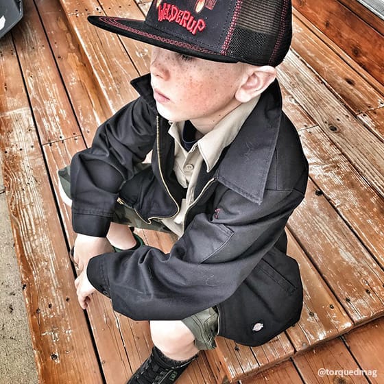 Kid sitting on wooden stairs