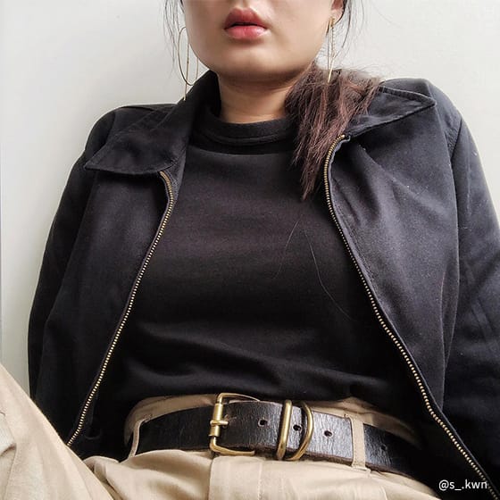 Woman sitting in black shirt and dark jacket