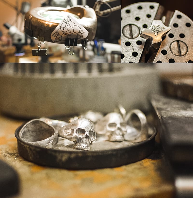 A larger reference drawing of a rose is clipped to Branden’s work light for the etching in progress on a tiny Texas. Skull rings fill a container nearby.