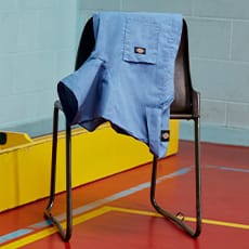 several dickies work shirts hanging on a wall