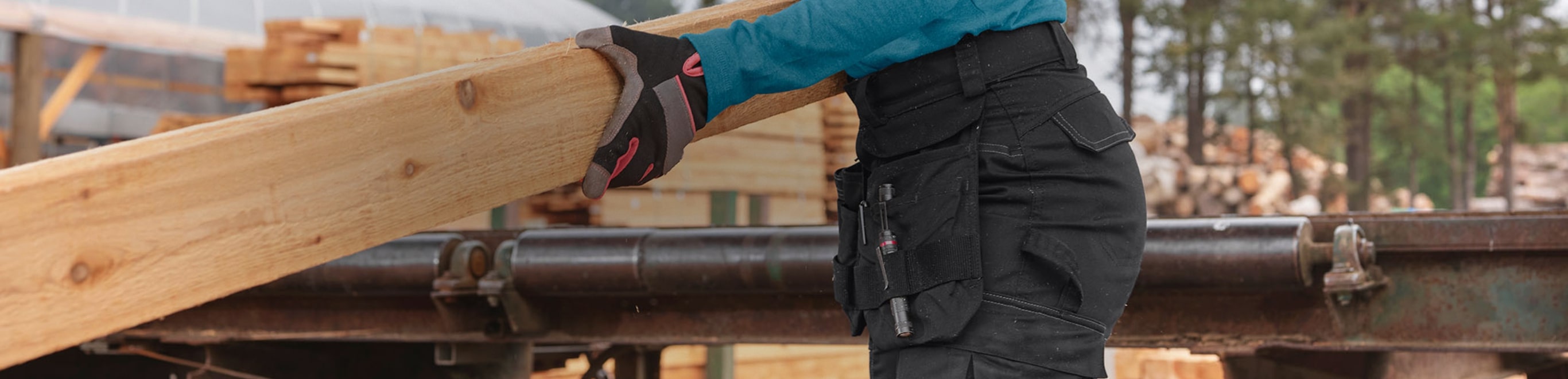 a woman handling a piece of engineered wood