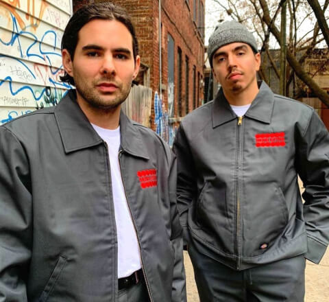 two men wearing eisenhower jackets