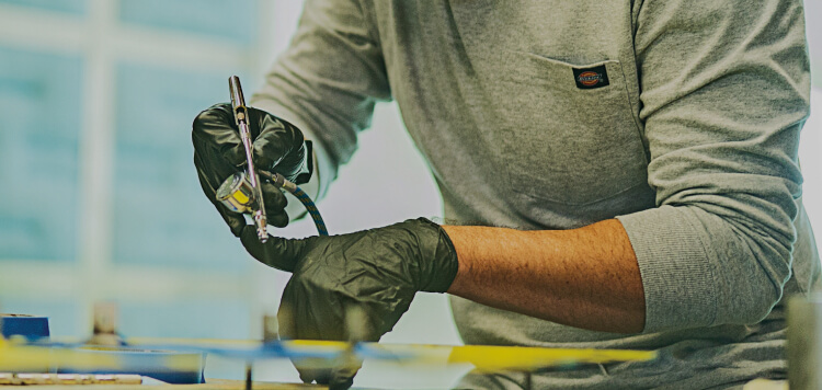 a worker using a spray paint men