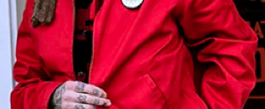 cropped image of a bearded man wearing a red jacket