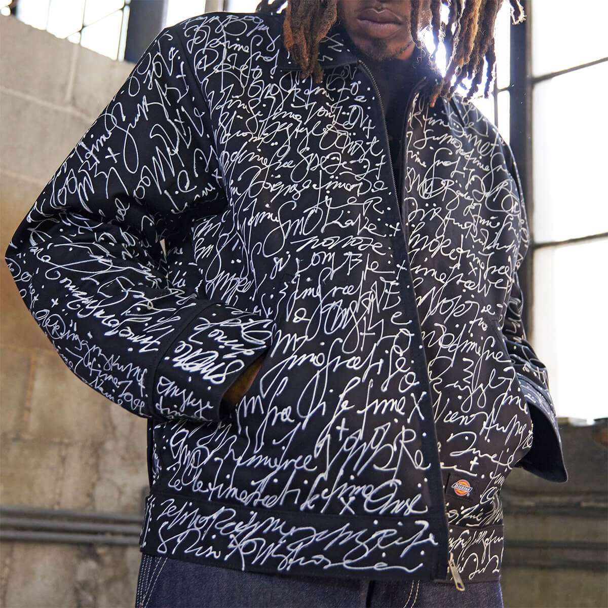 An eisenhower jacket altered with written text painted all over worn on a model.