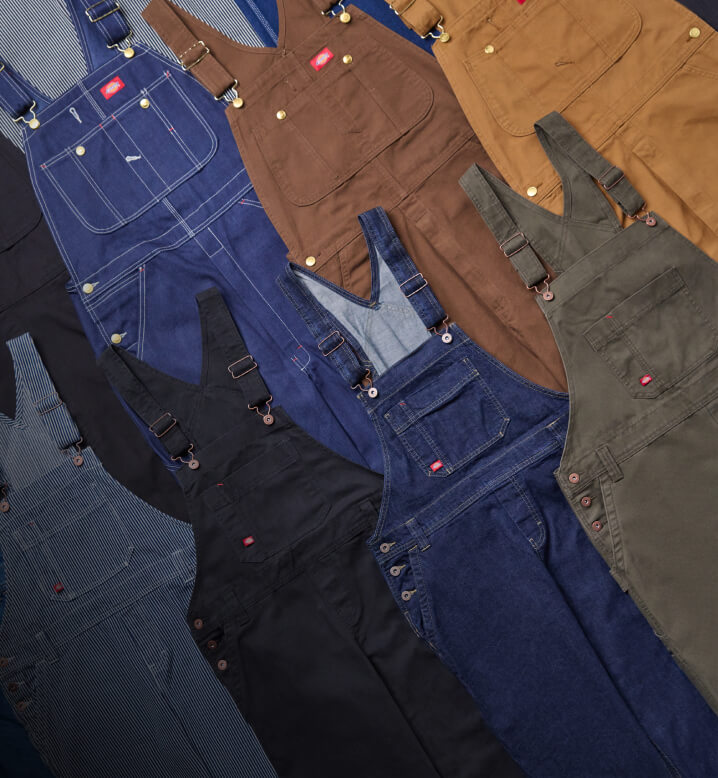 A stack of different colored overalls in a laydown view.