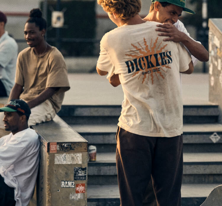 A group of people hanging around in a skatepark.