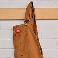 several dickies work shirts hanging on a wall