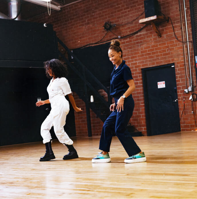 Kona and her mom practicing dance moves in a studio.