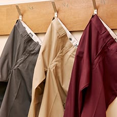three dickies 874 pants hanging on a wall