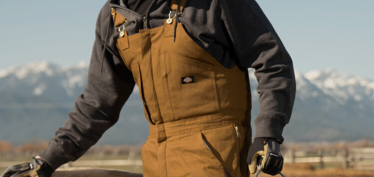 a man wearing duck brown overalls