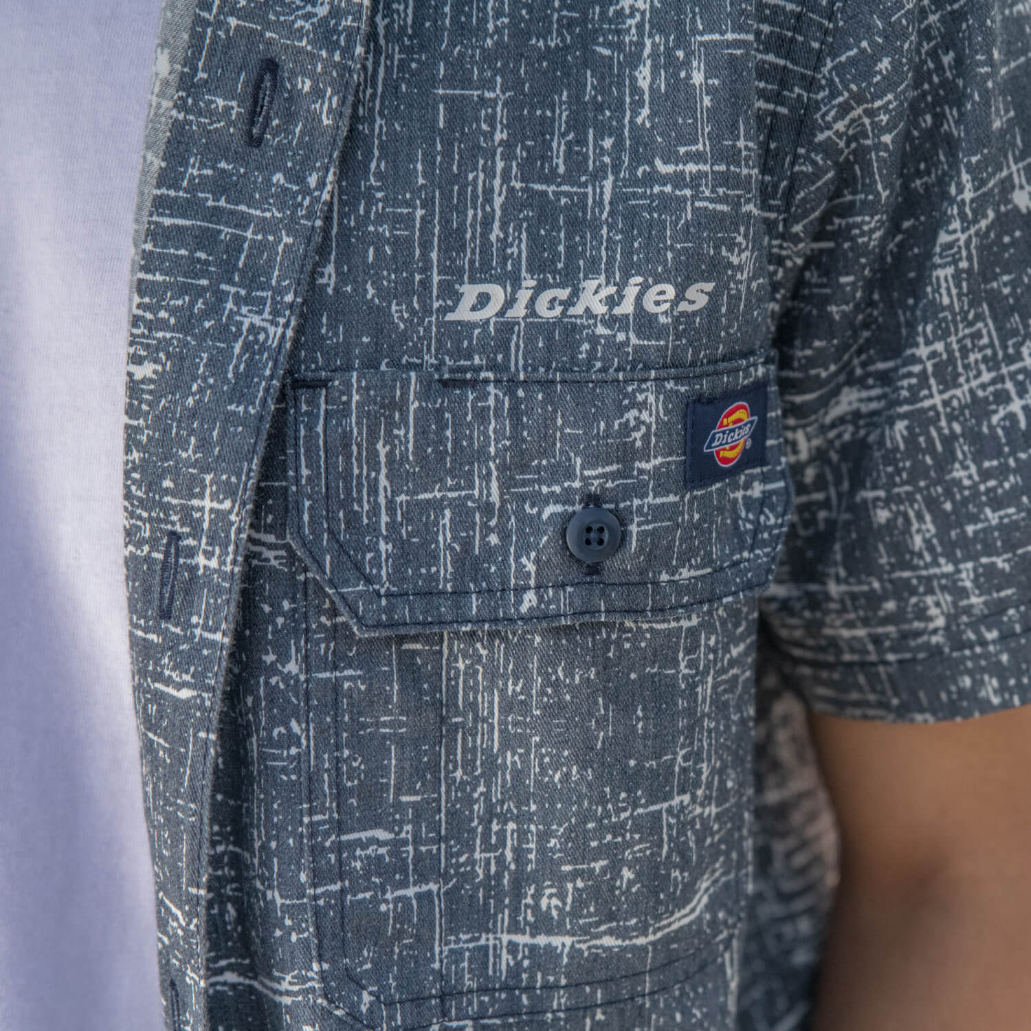 Close of up dickies blue and white cross hatch print clothing and matching uniform sets on the right