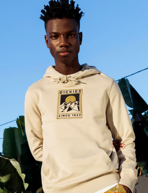 a man wearing a white dickies hoodie