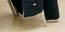several dickies work shirts hanging on a wall