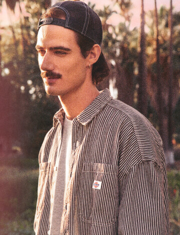 A man looking left in an outdoor setting.