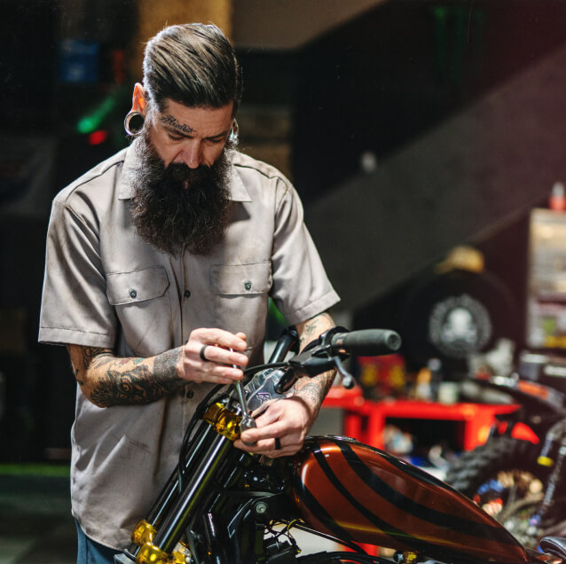 A mechanic working on a motorcycle.