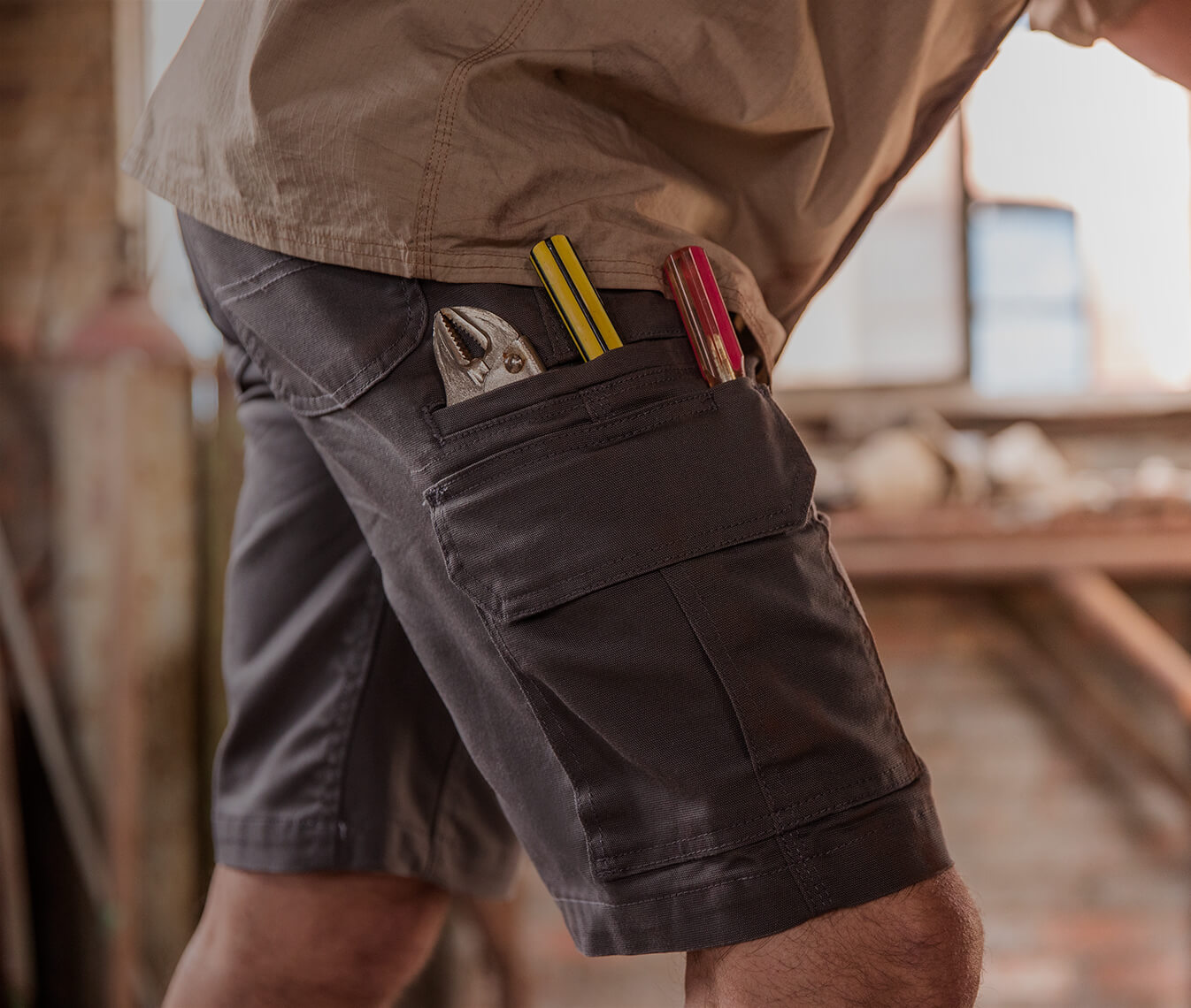 dark colored shorts with tools in the pockets