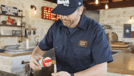 Matt Pittman applying rub to some food