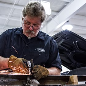 Welder, welding a piece of metal.