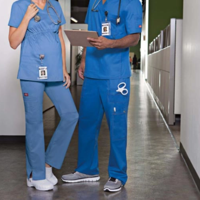 Two people wearing scrubs