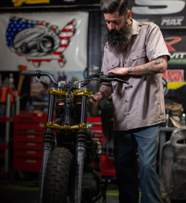 a man working on a motorcycle
