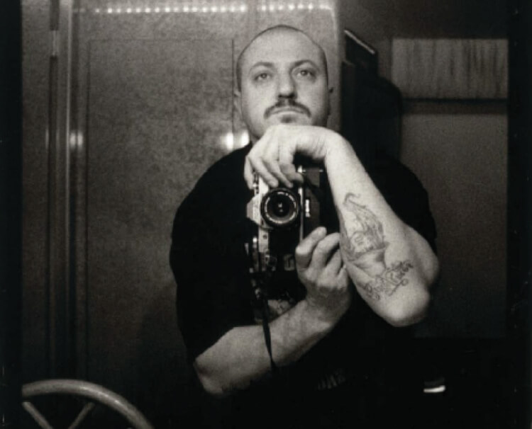Black and white photo of a man with a vintage camera